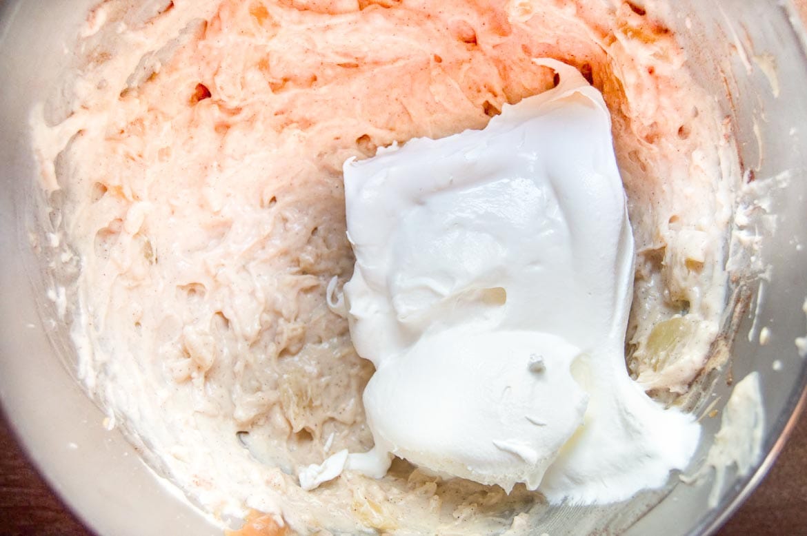 adding whipped topping to make Cream Cheese Caramel Apple Dip