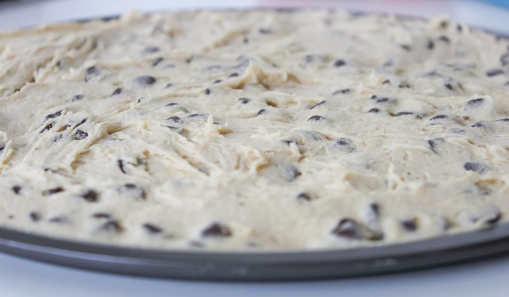 giant chocolate chip cookie cake dough ready to bake