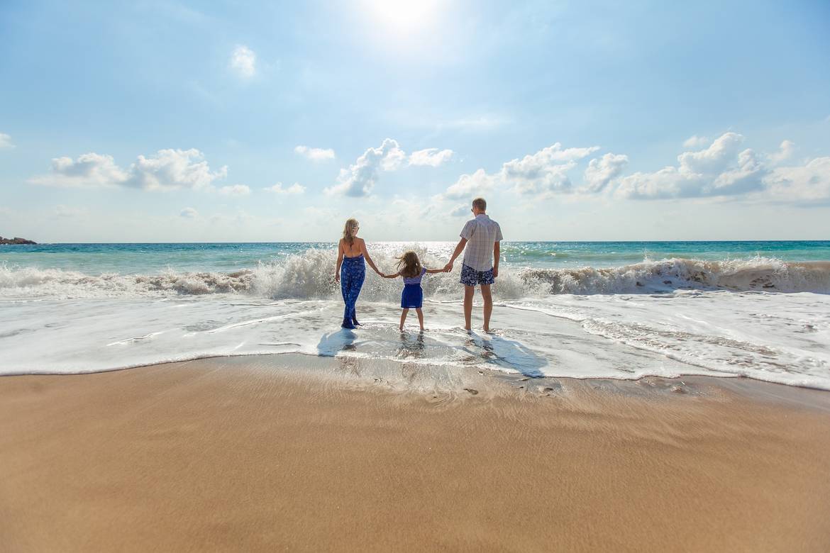 man woman and girl at the beach