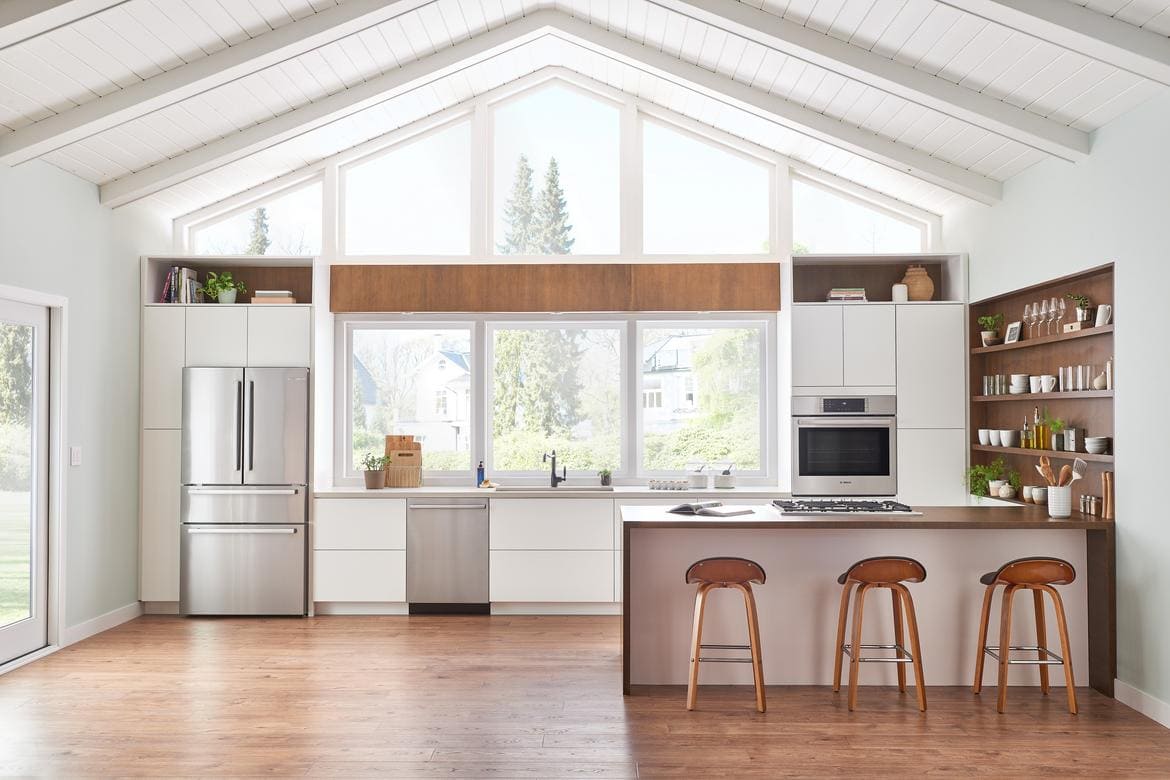 Bosch counter-depth refrigerator by window in kitchen