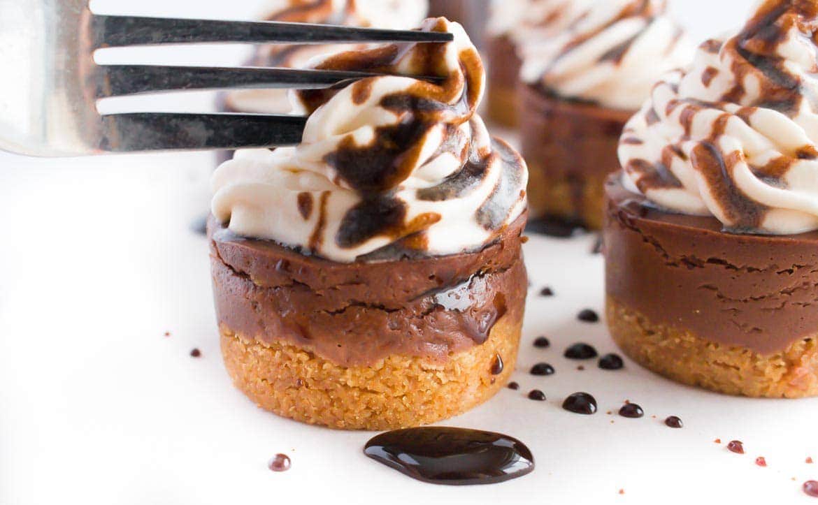 fork cutting into chocolate mini cheesecakes