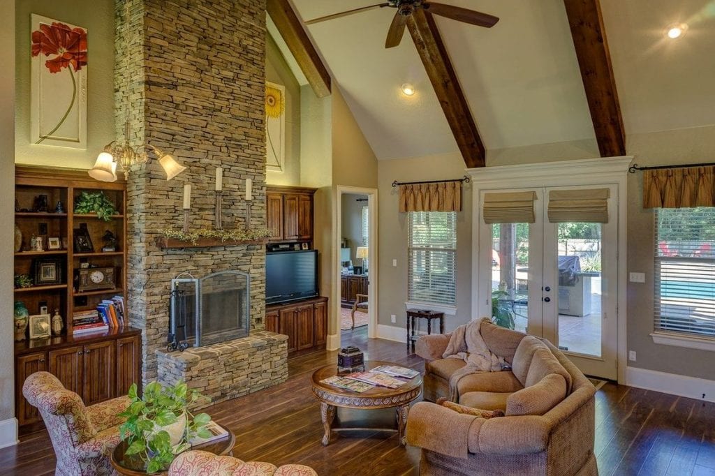home with fireplace wood floor and wood beams