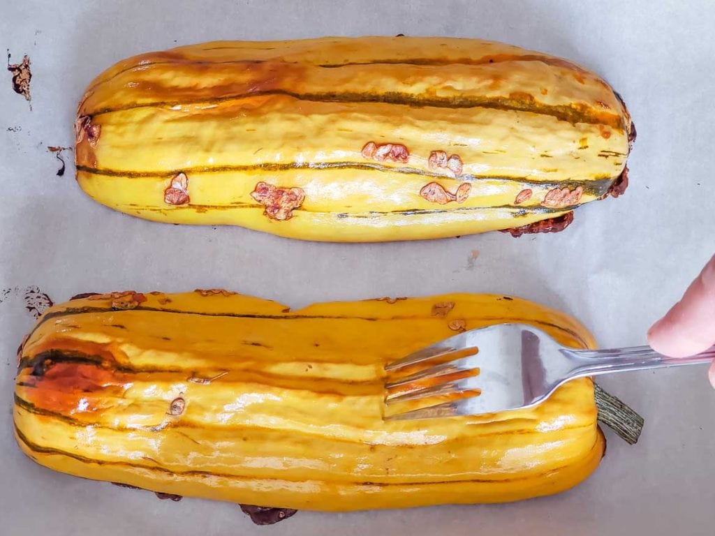 testing pan roasted delicata squash with fork to see if it's done