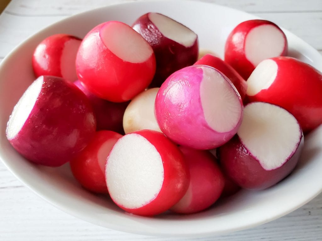 rainbow radishes in a white bowl