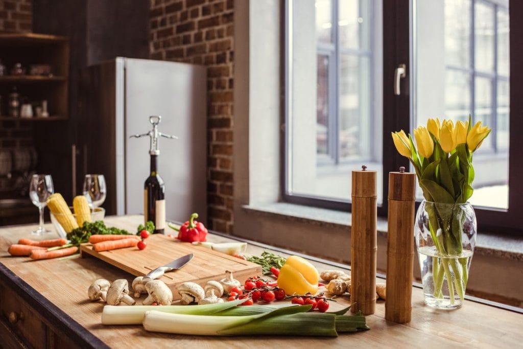 What to look for in a kitchen when buying or renting a home kitchen counter table with fresh veggies DP