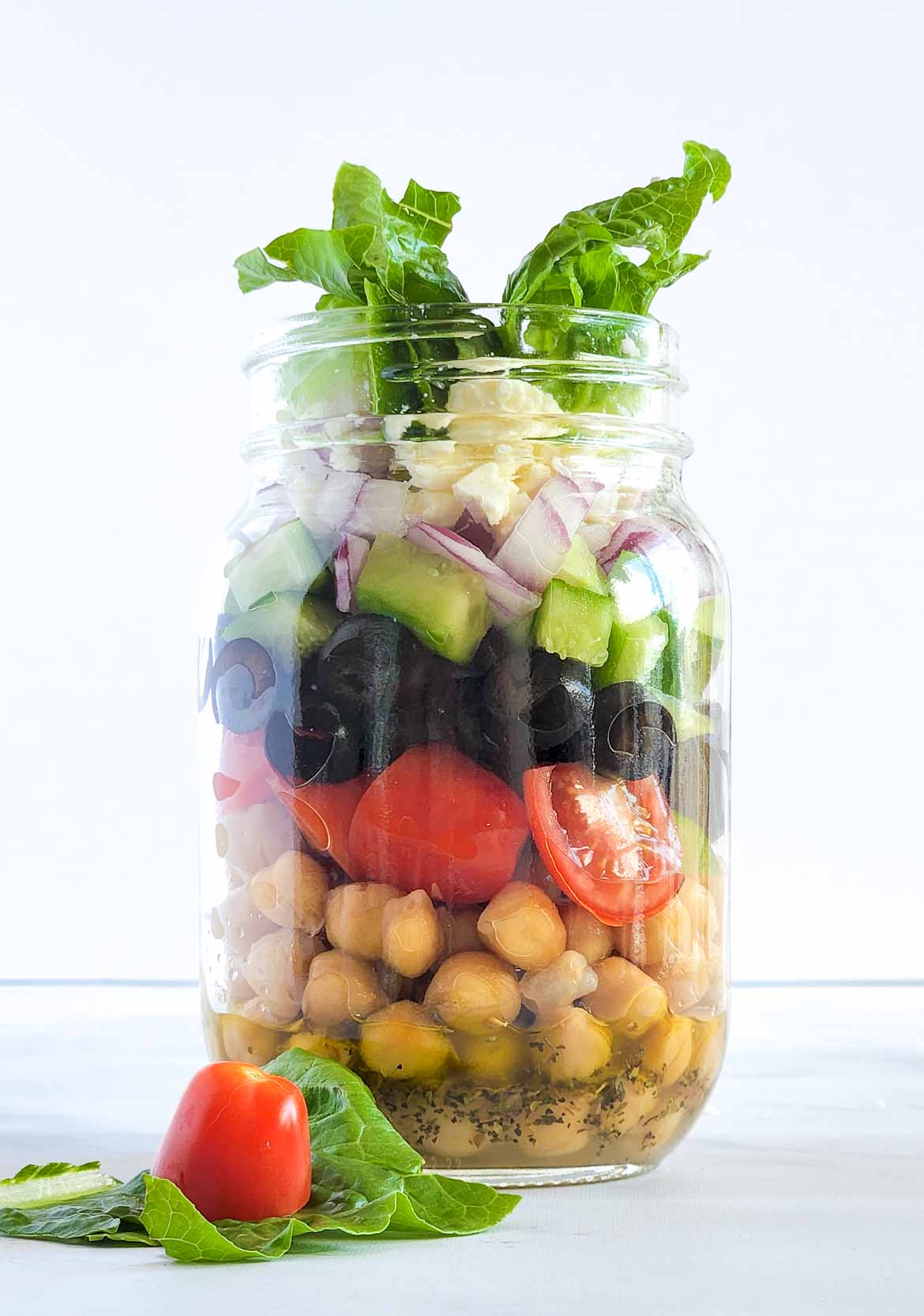 Greek salad in a mason jar with Chickpea Cherry Tomato and Feta