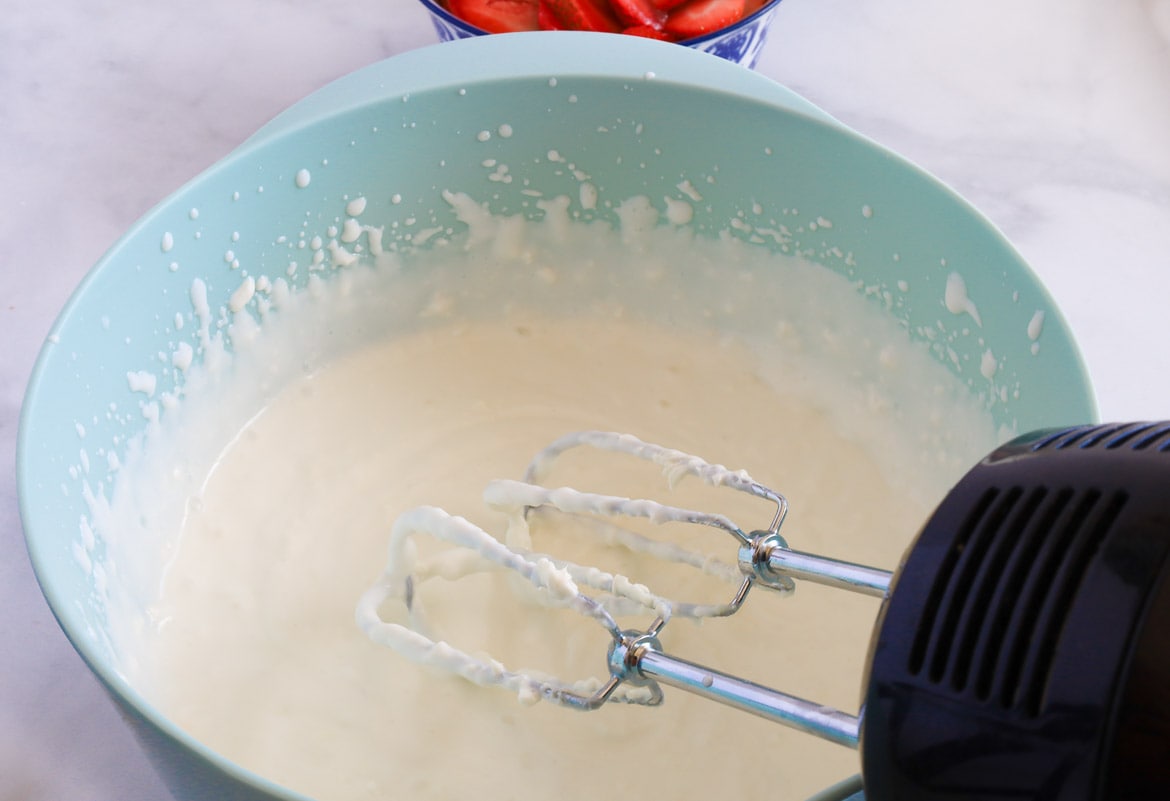 Mixing Greek Yogurt and Cream Cheese and milk for cheesecake popsicles