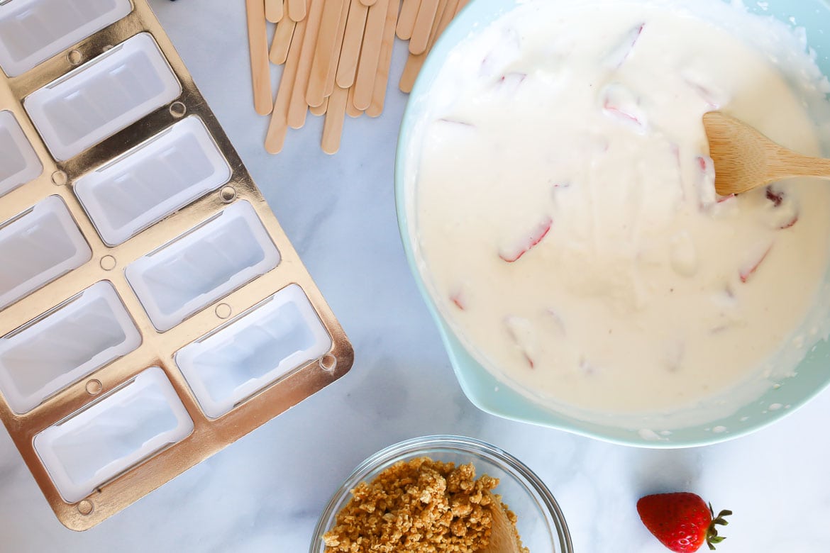 Strawberry cheesecake ice pops going into the mold