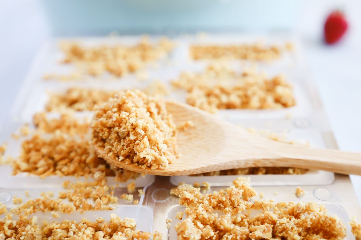 Adding graham cracker crust to berry cheesecake popsicles