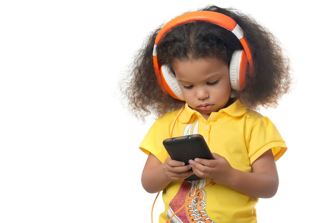 young child wearing orange headphones