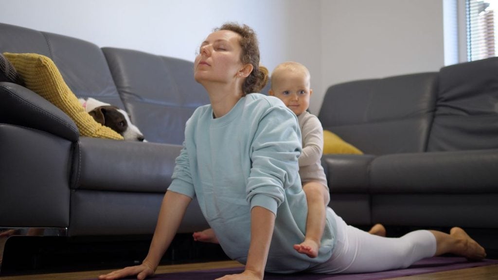 funny self care quotes Funny kid sitting on mom's back during her home yoga class. In-house physical activity and sport together with kids