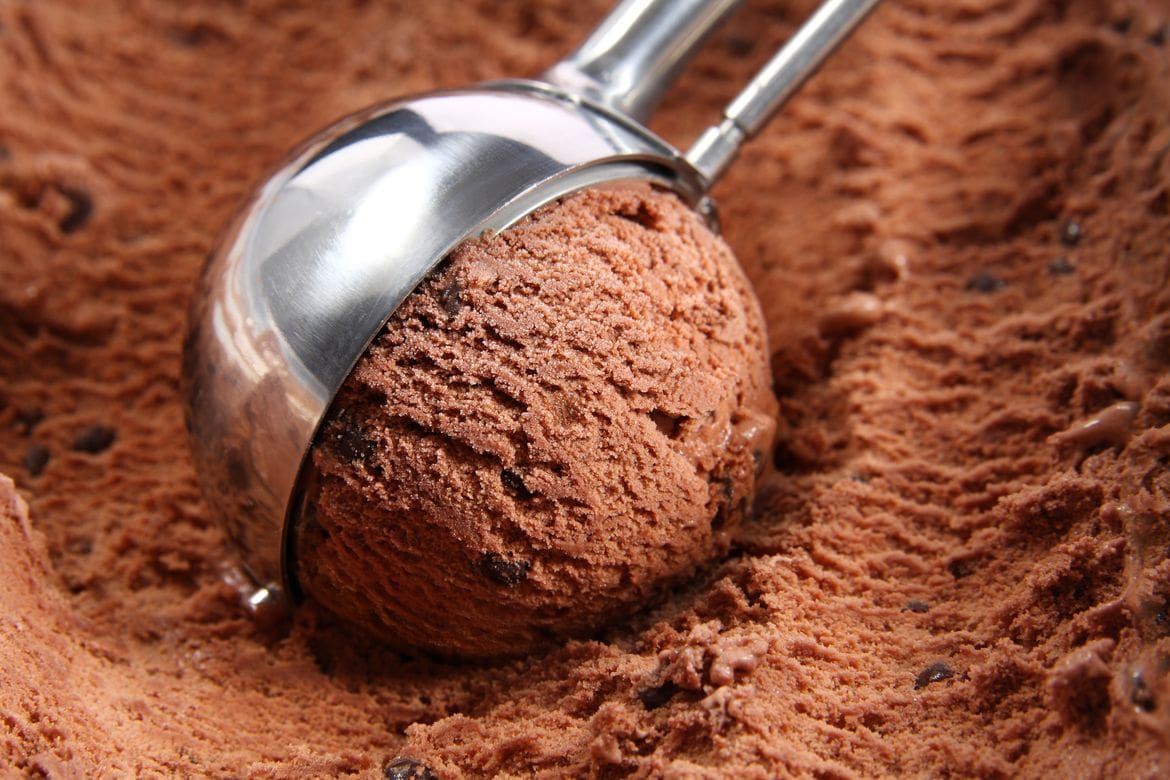 Chocolate ice cream and an ice cream scoop in a ice cream bar