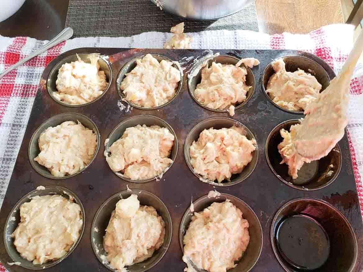apple cinnamon sour cream muffins in muffin tins