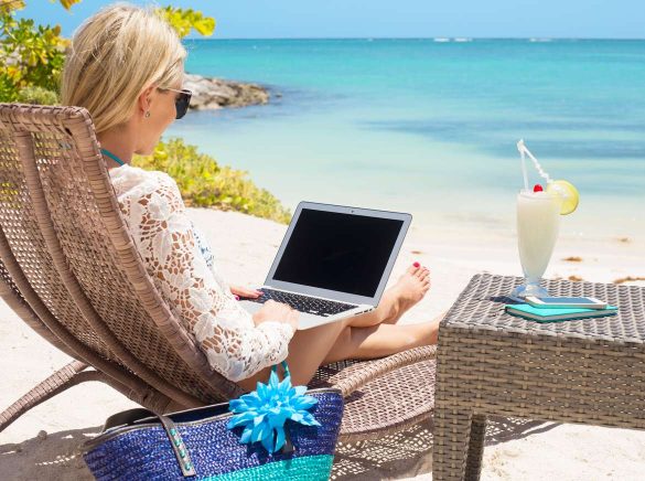 woman on a laptop on a beach