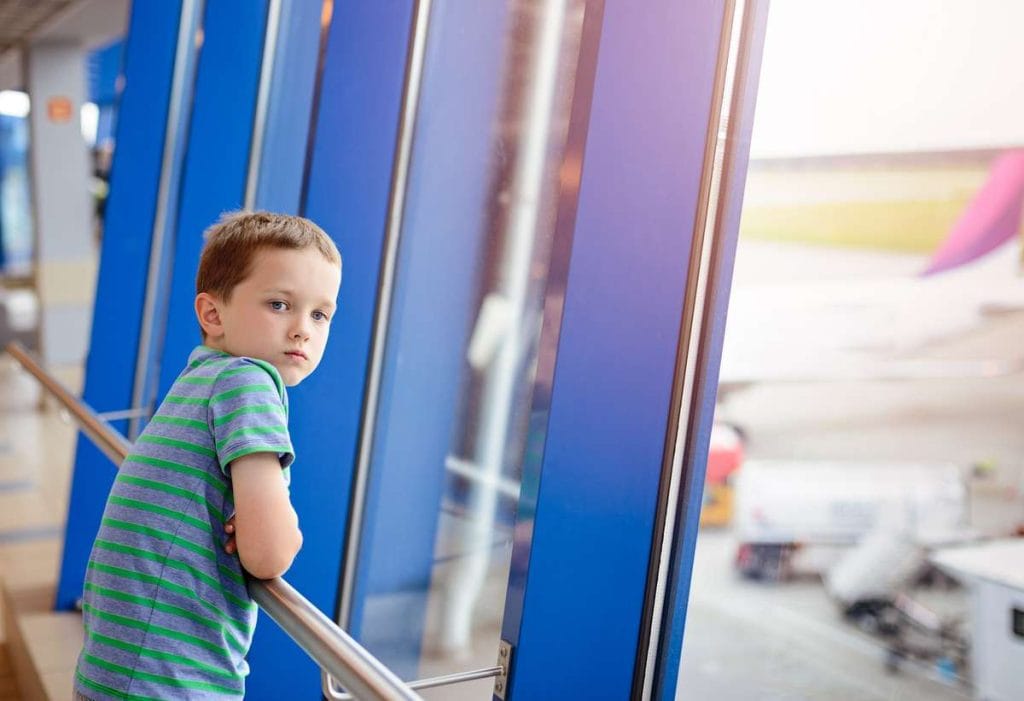 Child waits for airplane in the airport