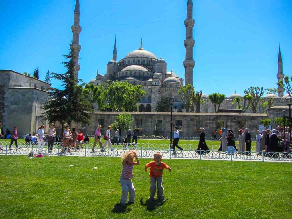 Kids playing in front of the Blue mosque in Istanbul Turkey