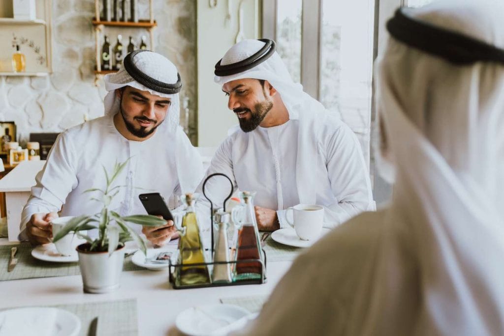 Three business men having a tea in Dubai