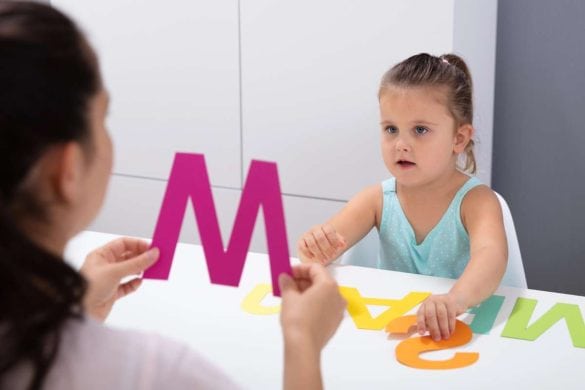 Young girl at speech language pathologist letter M DP