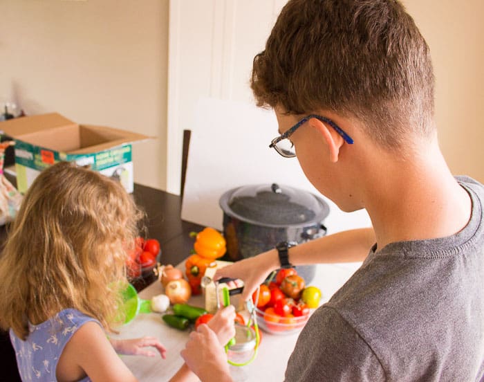 kids helping can fresh homemade tomato salsa