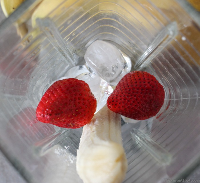 bananas and strawberries and ice and coconut milk in the blender