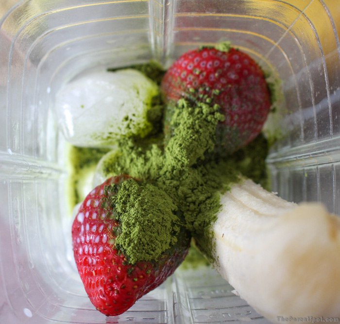 Blending a Ingredients for Matcha Green Tea smoothie with bananas and strawberries